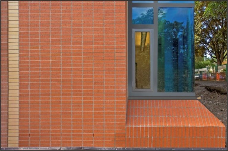 This corner window detail features a sloping brick sill.
