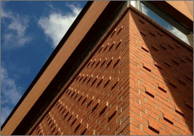 This bold detail employs a Flemish bond pattern with a staggered, corbelled header variation.