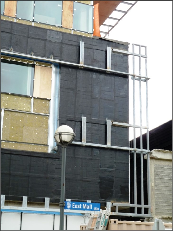 These before and after photos illustrate the back-up and lintel support system for the brick veneer. The steel angle lintel over the window has been extended horizontally through the body of the wall to provide a control joint to accommodate possible thermal movements.